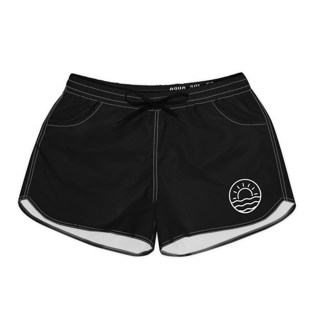 Aqua Sol Company black quick-dry coastal shorts with white contrast stitching, elastic waistband, and sunrise emblem.